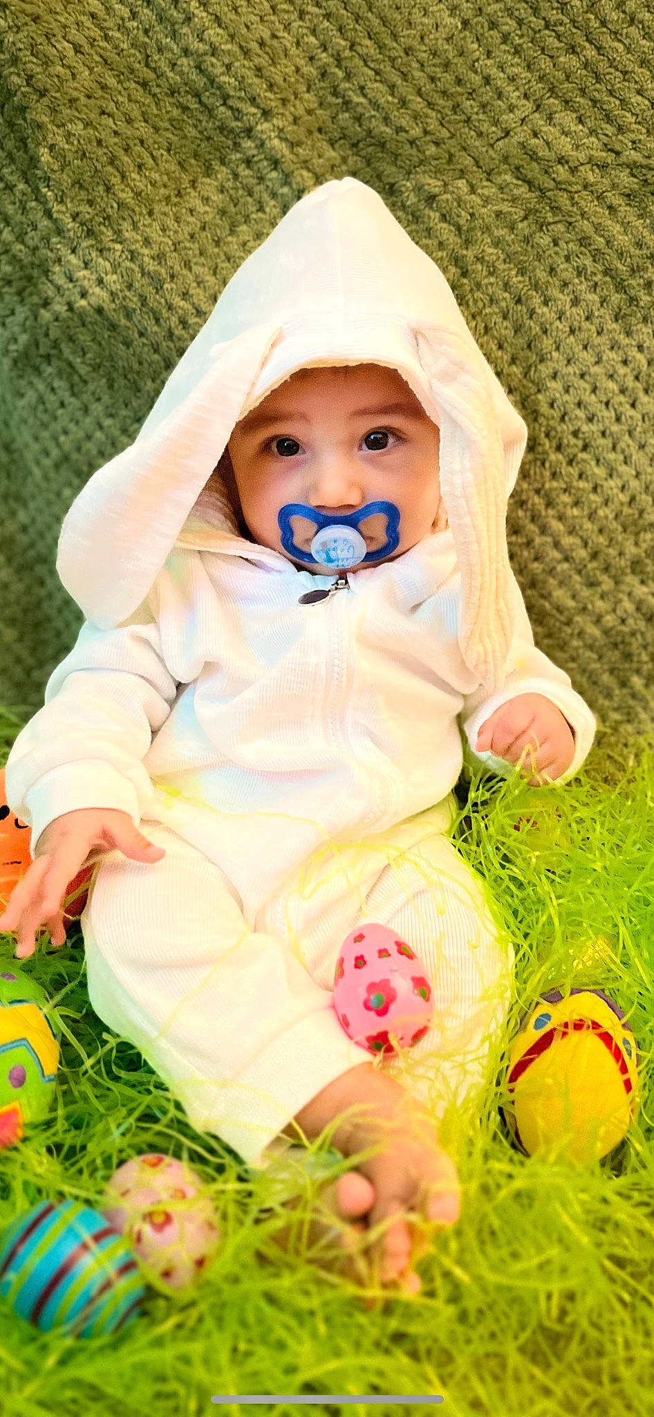 Abraham is registered to the contest to win money with this photo: baby, baby_products, baby_toddler_clothing, cheek, child, doll, facial_expression, grass, happy, headwear, illustration, linens, mammal, pattern, people_in_nature, person, pink, spring, textile, toy