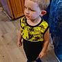 Lathan joined the competition — help win amazing prizes! child, indoor, yellow_shirt, blue_shoes, wooden_cabinet, flooring, curious_expression, short_hair, standing, person, casual_clothing, home, furniture, young_boy, room, light, looking_away, young_child, floor, cabinet