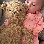 Emma joined the competition — help win amazing prizes! baby, infant, teddy_bear, stuffed_animal, pink_outfit, hearts, blanket, pillow, cute, portrait, lying_down, soft_toy, sleepwear, plush, one_person, face, eyes, hand, cuddling, bedroom