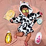 baby, infant, cucumber_slices, bathrobe, cow_pattern, pink_blanket, baby_bath_products, johnsons, wooden_sign, 3_months, cute, relaxation, skin_care, child, hooded_garment, soft_texture, lying_down, toddler, spa_day, adorable