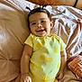 Zaylie is registered to the contest to win money with this photo: baby, smile, yellow_onesie, lemon_pattern, pigtails, bed, blanket, infant, cute, happy, child, indoors, person, soft_lighting, portrait, skin, hand, head, earrings, cozy