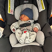 Joldy is registered to the contest to win money with this photo: newborn, baby, car_seat, chicco, sleeping, infant, hat, pajamas, safety_harness, child, cute, resting, indoors, seat, soft, small, peaceful, comfort, sleep, bundle