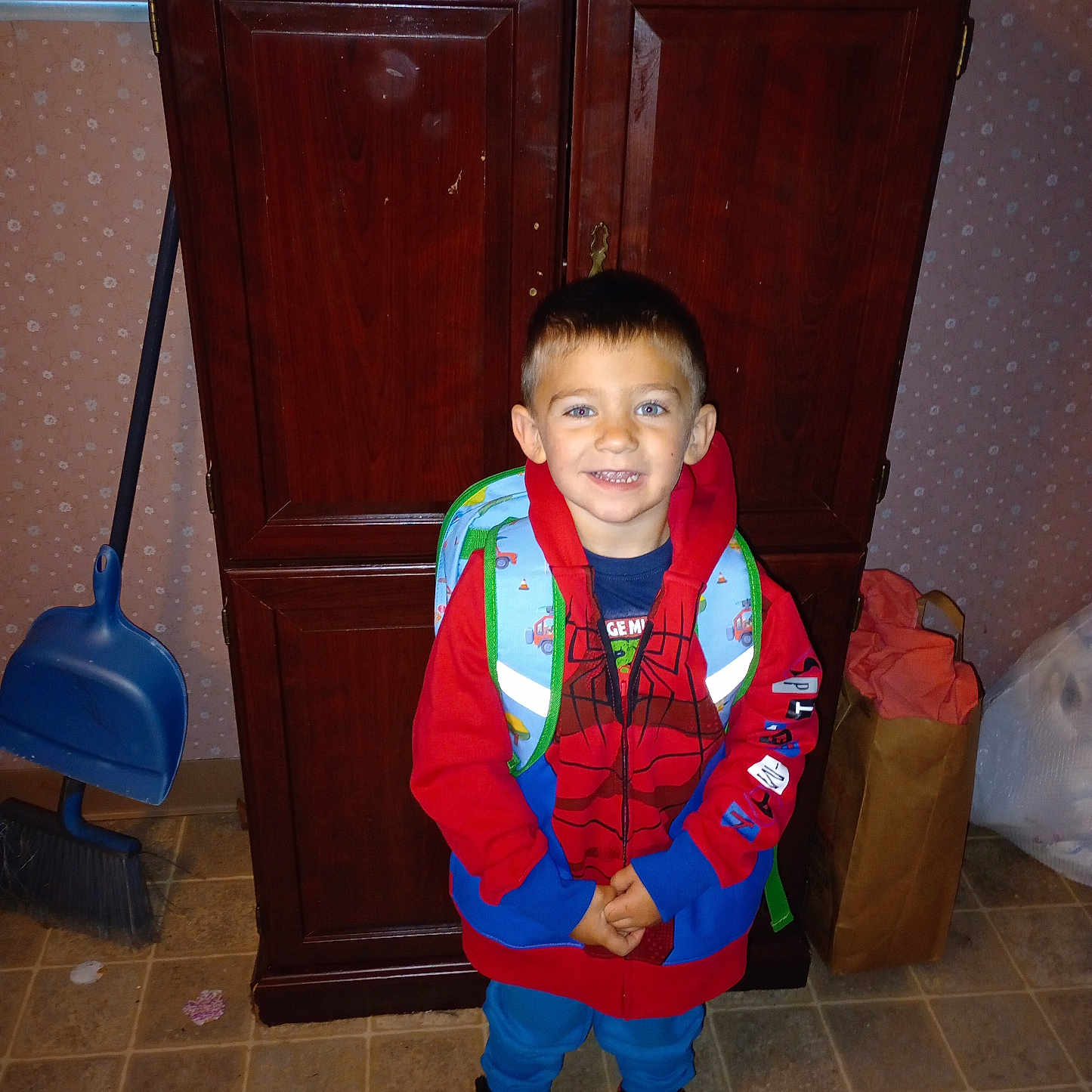 Ryder is registered to the contest to win money with this photo: accessories, bag, boy, cabinet, child, closet, clothing, cupboard, face, footwear, furniture, handbag, head, lifejacket, male, person, photography, shoe, vest, wood