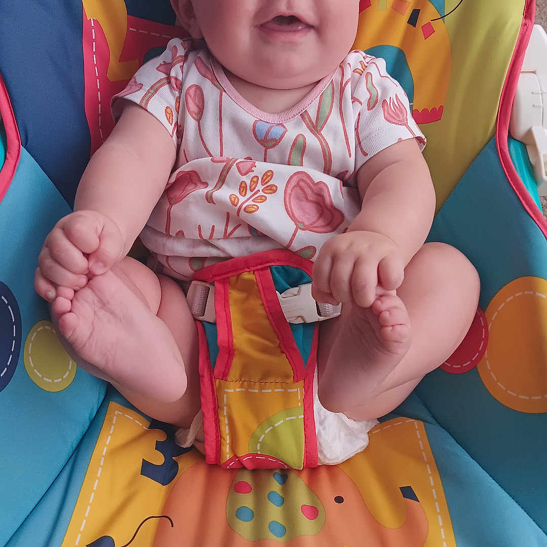 Leenna joined the competition — help win amazing prizes! animal_print, baby, baby_seat, child, colorful, comfort, cute, fisher_price, foot_holding, happy, indoors, infant, onesie, playful, portrait, seat_belt, sitting, smiling, toy, young_child