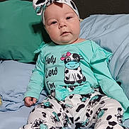 Leenna joined the competition — help win amazing prizes! baby, child, infant, cute, cow_print, headband, clothing, pajamas, bed, pillow, blue, green, feet, sitting, face, person, indoors, soft, comfortable, expression