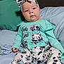 Leenna joined the competition — help win amazing prizes! baby, child, infant, cute, cow_print, headband, clothing, pajamas, bed, pillow, blue, green, feet, sitting, face, person, indoors, soft, comfortable, expression