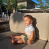 Zayden is registered to the contest to win money with this photo: toddler, child, outdoor, couch, beige, sunlight, smile, shorts, shirt, fountain, trees, blue_sky, daylight, relaxing, summer, shadow, bench, park, person, happy
