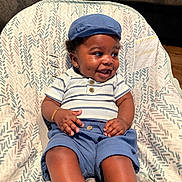 Royal Mize joined the competition — help win amazing prizes! baby, smiling, child, blue_cap, blue_shorts, striped_shirt, sitting, baby_seat, dimples, happy, indoor, bracelet, infant, cute, clothing, person, furniture, patterned_fabric, portrait, casual