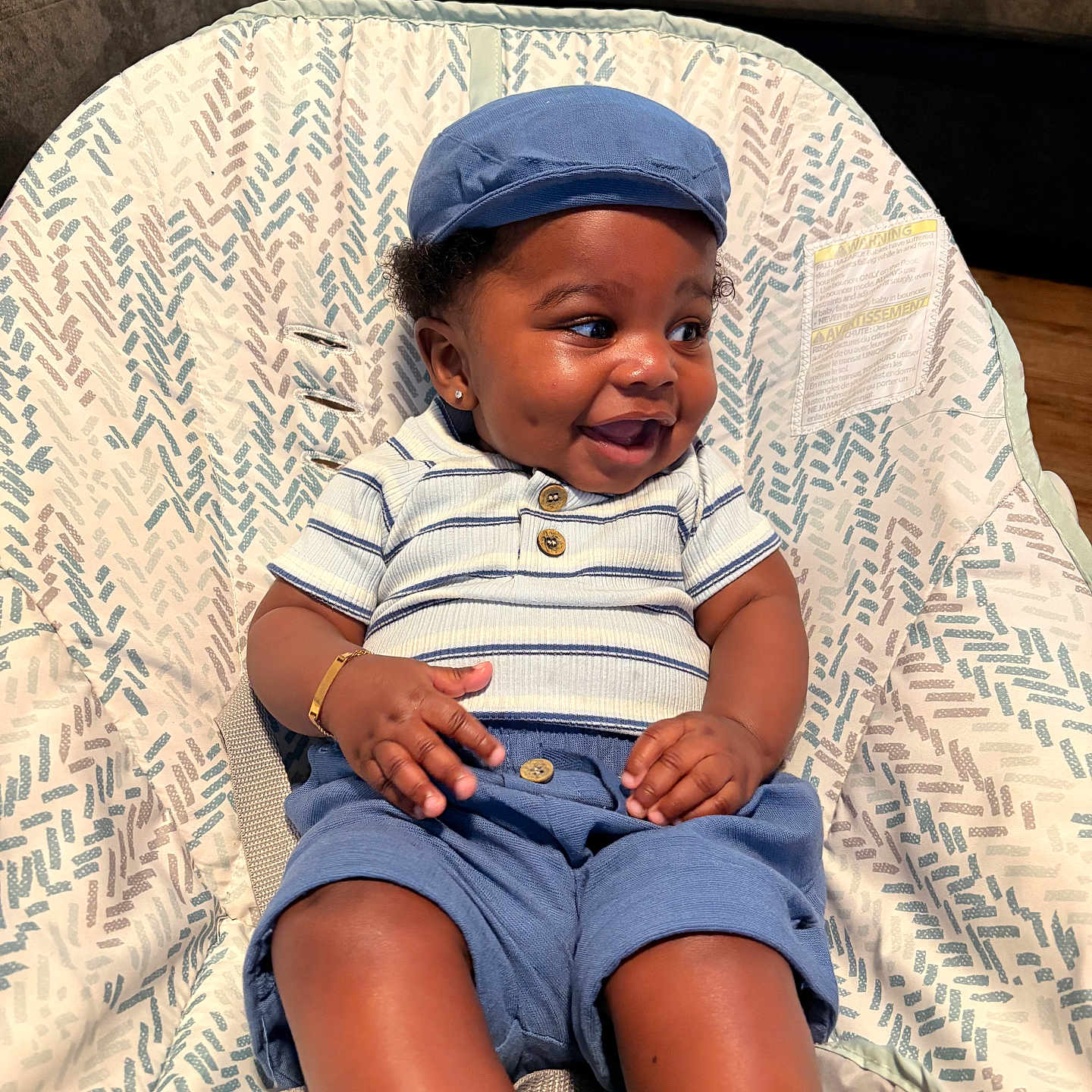 Royal Mize joined the competition — help win amazing prizes! baby, baby_seat, blue_cap, blue_shorts, bracelet, casual, child, clothing, cute, dimples, furniture, happy, indoor, infant, patterned_fabric, person, portrait, sitting, smiling, striped_shirt