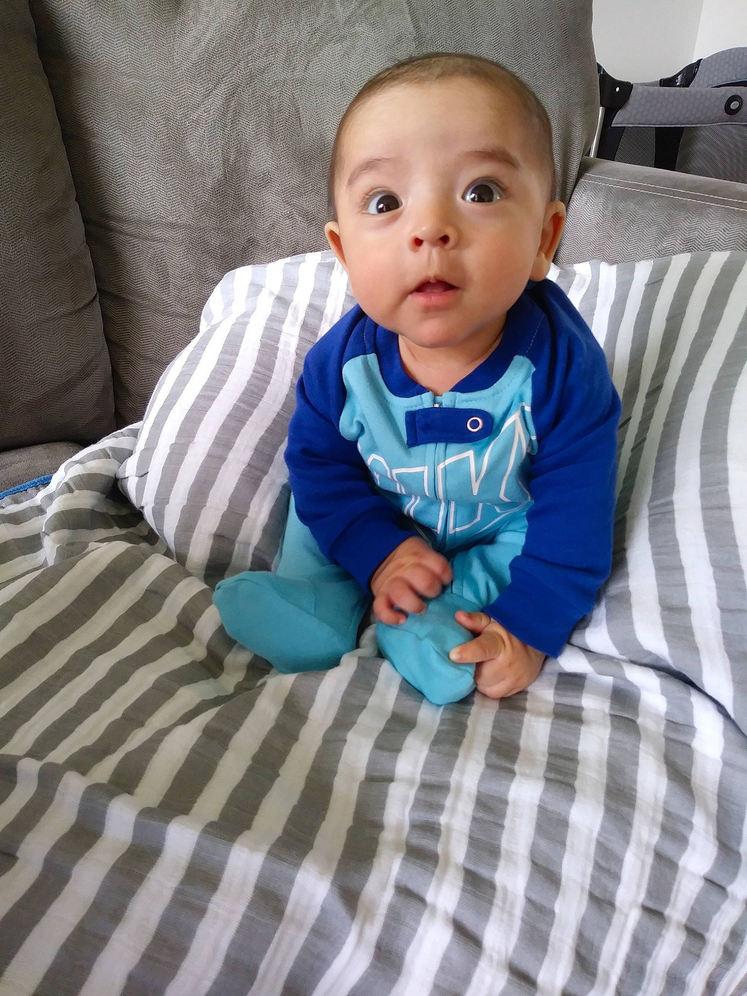 Abram is registered to the contest to win money with this photo: baby, baby_products, baby_toddler_clothing, blanket, cheek, child, eye, face, head, linens, person, product, sitting, skin, textile, toddler