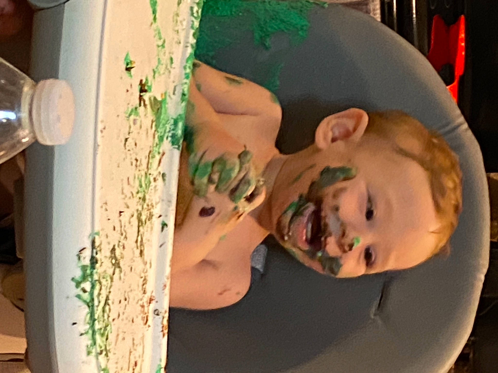 Nicholas is registered to the contest to win money with this photo: arm, art, baby, child, design, dishware, drinkware, finger, food, fun, green, happy, hat, mouth, pattern, person, plate, room, serveware, toddler