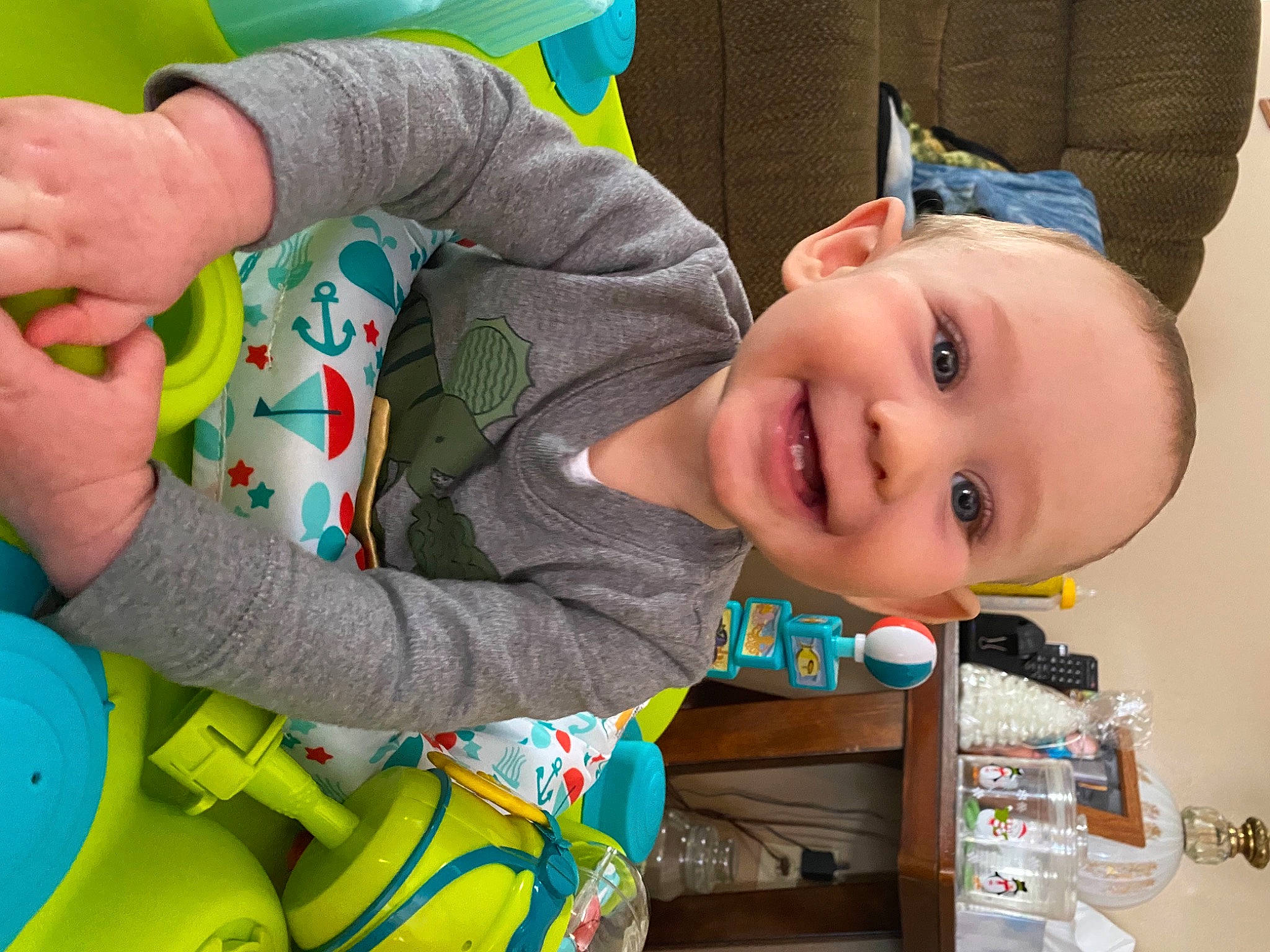 Nicholas is registered to the contest to win money with this photo: baby, baby_products, baby_toddler_clothing, cheek, facial_expression, finger, fun, green, hand, happy, human_body, joy, leisure, nose, person, product, skin, smile, textile, toddler