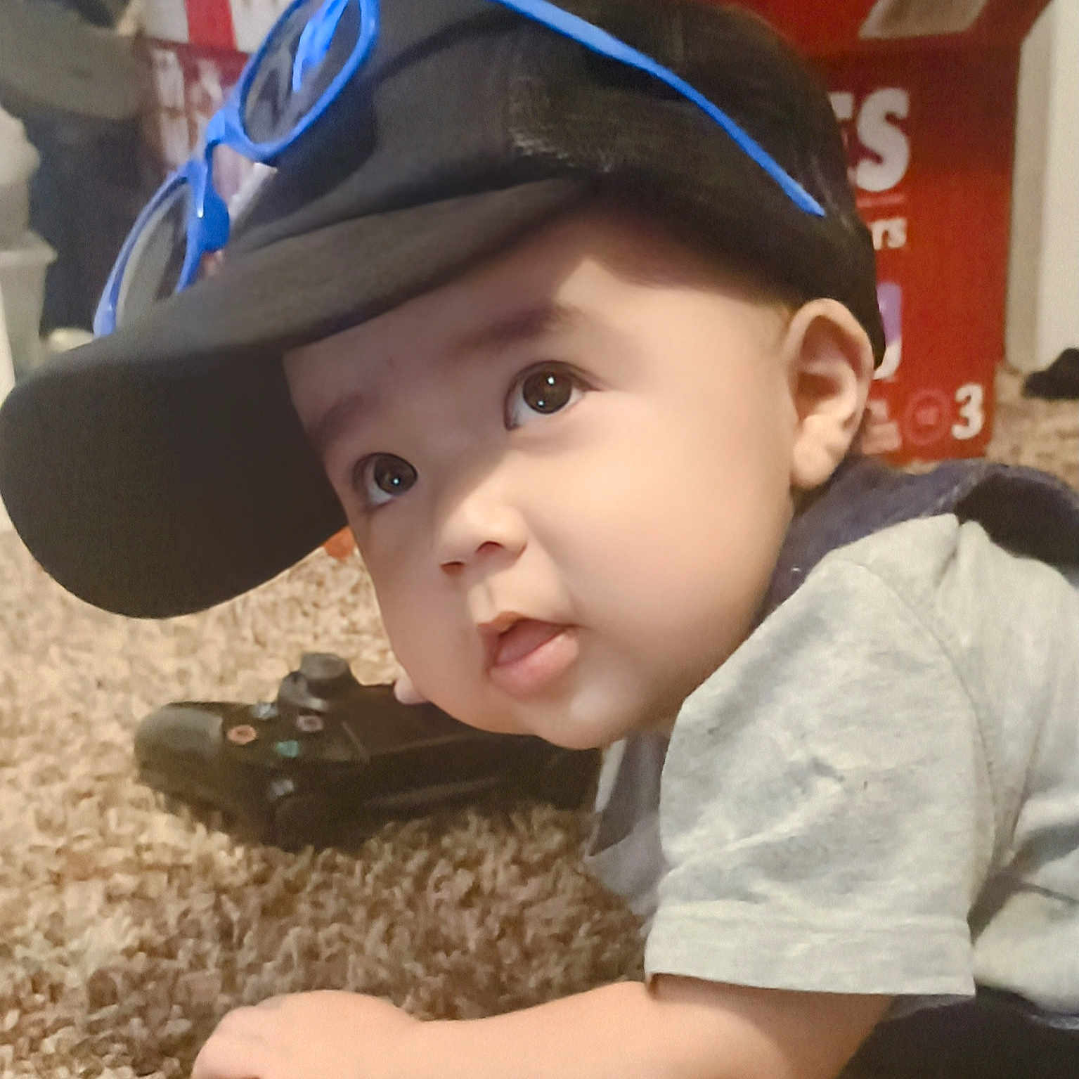 Jadiel joined the competition — help win amazing prizes! baby, cap, carpet, casual, child, clothing, controller, crawling, curious, cute, face, gaming, hand, headwear, indoor, infant, person, sunglasses, toy, young