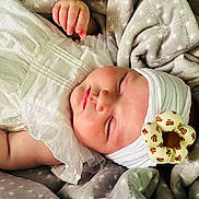 Louise participe au concours pour gagner de l'argent avec cette photo : baby, sleeping, infant, white_dress, headband, flower, blanket, soft_texture, peaceful, closeup, portrait, child, cute, adorable, resting, cozy, fabric, newborn, toddler, skin