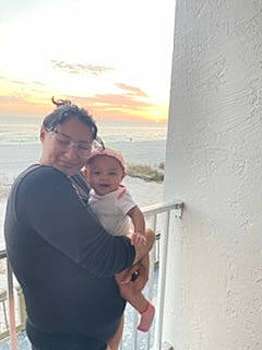 Diana is registered to the contest to win money with this photo: baby, blurred, cloud, event, eyewear, fun, gesture, goggles, happy, horizon, hug, leisure, ocean, person, room, sky, sunglasses, toddler, tourism, travel