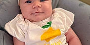 Livia participe au concours pour gagner de l'argent avec cette photo : baby, bow, child, closeup, clothing, comfort, cushion, cute, face, headband, indoor, infant, lemon_graphic, person, portrait, relaxation, sitting, smiling, white_shirt, yellow_pants