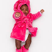 Legacy is registered to the contest to win money with this photo: baby, infant, child, pink_robe, booties, diaper, cute, playful, portrait, studio, smile, fist, soft, fluffy, warm_clothing, isolated, white_background, fashion, happy, young