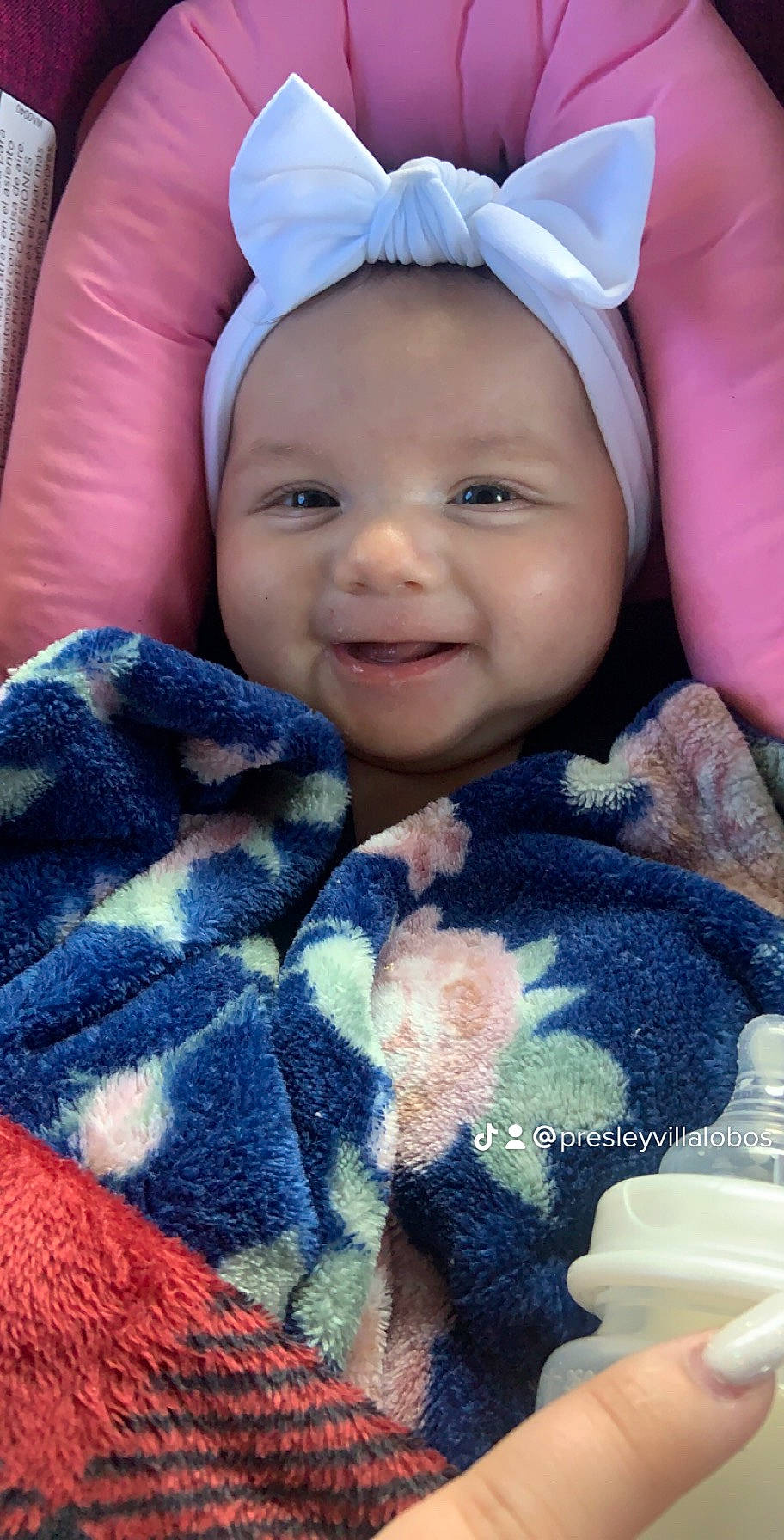 Jenae is registered to the contest to win money with this photo: azure, baby, cap, comfort, cup, eye, face, finger, happy, head, headgear, headwear, outerwear, people, person, pink, purple, serveware, skin, smile