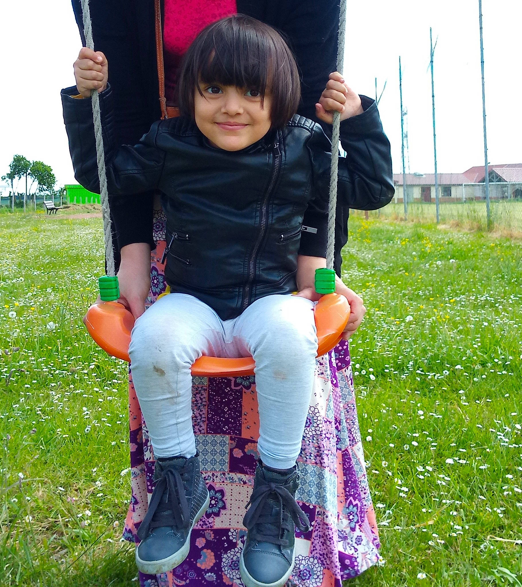 Émilie participe au concours pour gagner de l'argent avec cette photo : baby_toddler_clothing, bangs, boot, child, child_model, cool, footwear, human_settlement, joy, knee, lavender, leg, meadow, outdoor_play_equipment, outdoor_shoe, person, play, shoe, sock, swing