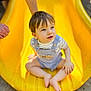 toddler, child, yellow_slide, playground, outdoor, baby, sitting, curious, short_hair, overalls, striped_shirt, barefoot, person, daylight, fun, play, summer, hand, concrete, park