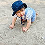 toddler, child, baby, hat, bucket_hat, overalls, striped_shirt, sand, outdoor, crawling, cute, curious, young_child, exploring, summer, daylight, skin, face, hands, play