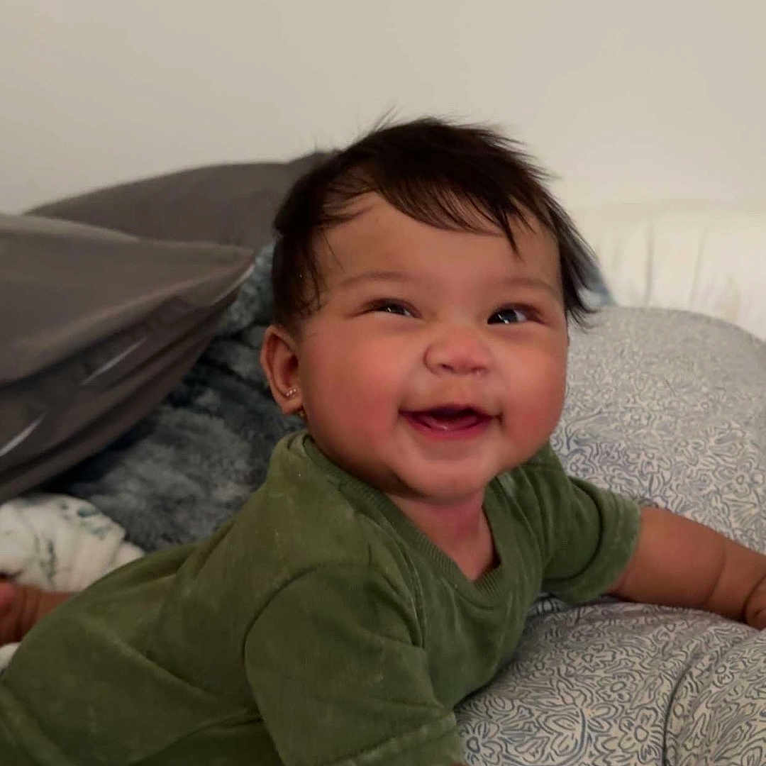 Lylian joined the competition — help win amazing prizes! baby, babylaughing, bed, bedroom, clothing, couch, cushion, face, furniture, happy, head, homedecor, indoors, laughing, pants, person, photography, portrait, room, smile