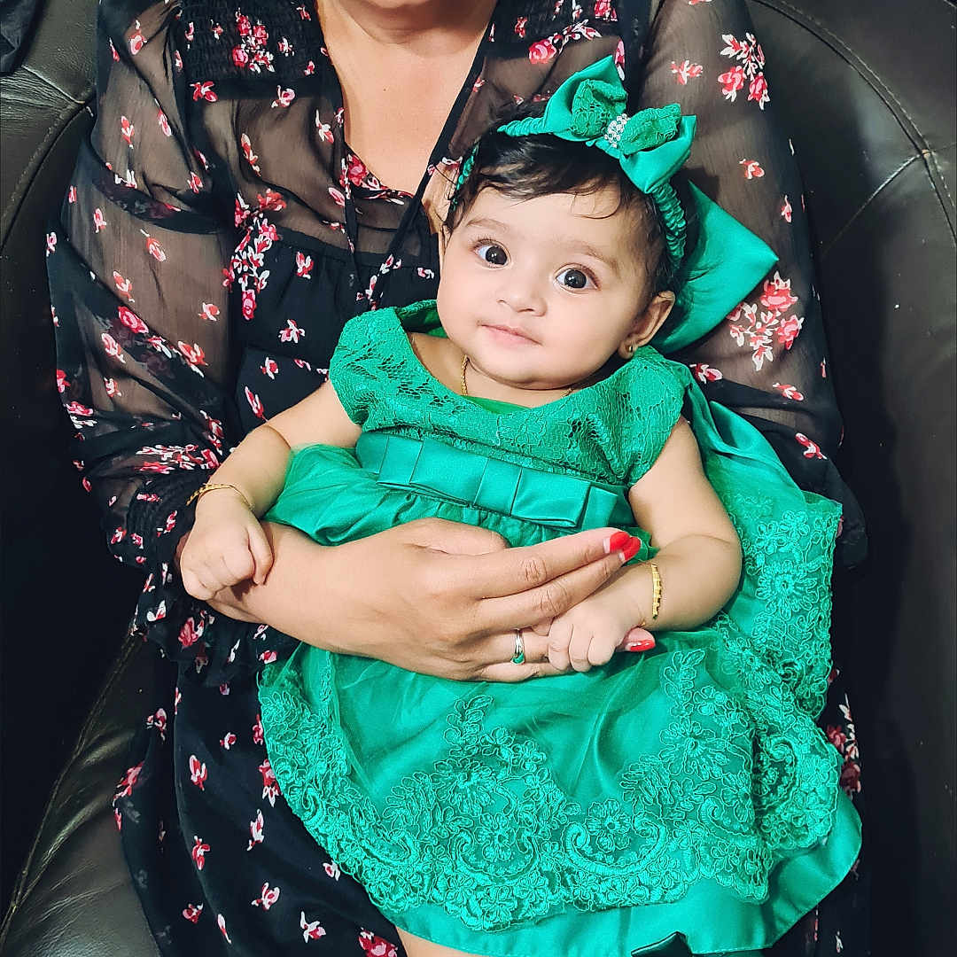 Adhanya joined the competition — help win amazing prizes! accessories, baby, bracelet, chair, child, cute, fashion, floral_pattern, glasses, green_dress, happy, headband, holding, indoor, person, portrait, ring, sitting, smiling, woman