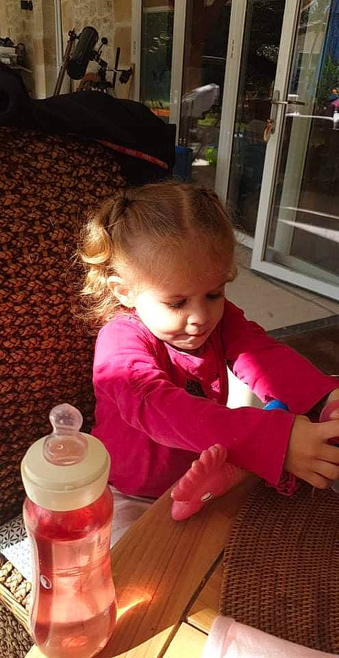 Lylarose participe au concours pour gagner de l'argent avec cette photo : baby, baby_toddler_clothing, bottle, cheek, child, drink, drinkware, flooring, food_storage_containers, fun, hardwood, person, plastic_bottle, room, salt_and_pepper_shakers, sitting, skin, smile, toddler, window