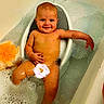 baby, bath_seat, bathroom, bathtub, bubble_bath, child, clean, cute, flower_sticker, foam, happy, indoors, infant, one_person, relaxing, sitting, skin, smiling, water, young_child