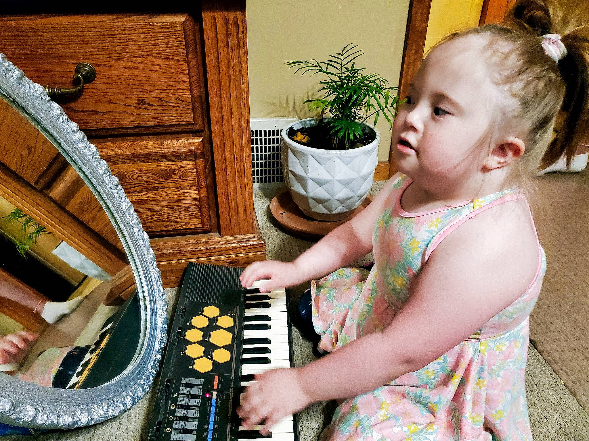 Ashia is registered to the contest to win money with this photo: automotive_tire, bicycle_tire, child, flowerpot, houseplant, input_device, keyboard, keyboard_player, leisure, musical_instrument, musical_keyboard, office_equipment, person, pianist, plant, rim, sitting, toddler, tread, wheel