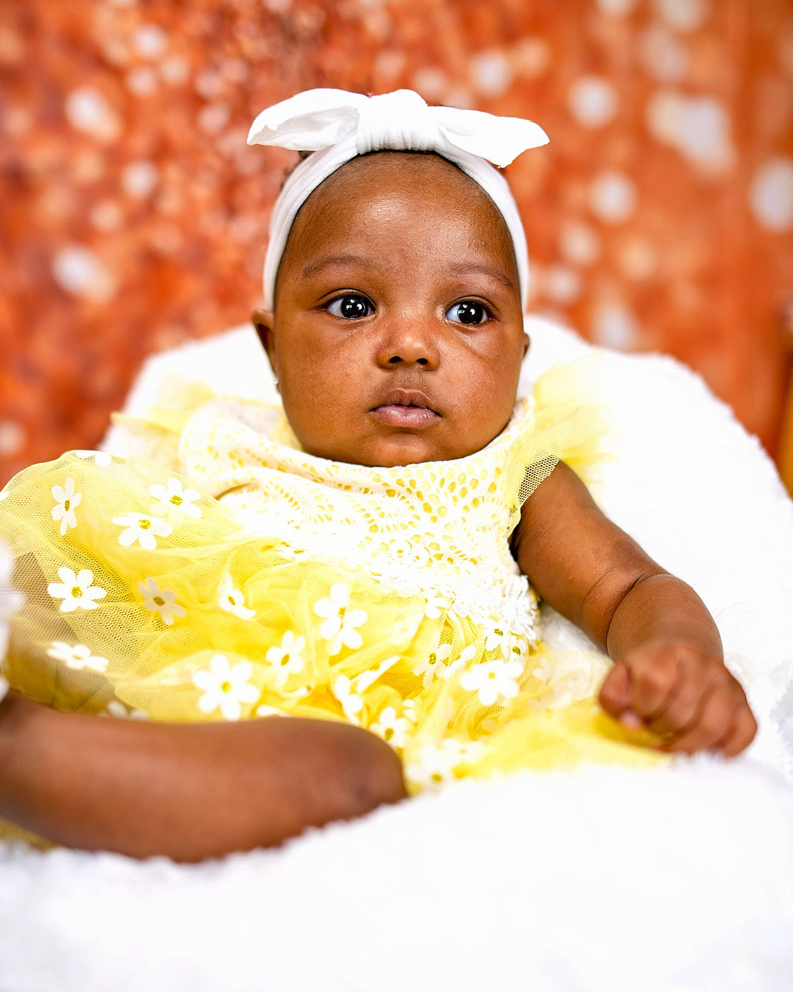 Kailani is registered to the contest to win money with this photo: baby, baby_toddler_clothing, child, comfort, event, eye, fashion_accessory, fun, happy, head, peach, people_in_nature, person, portrait_photography, sitting, sleeve, toddler, tradition