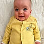Sunni is registered to the contest to win money with this photo: baby, infant, yellow_clothing, winnie_the_pooh, onesie, smiling, face, hands, cute, child, portrait, lying_down, soft_fabric, expression, indoors, baby_clothes, newborn, closeup, warm_colors, adorable