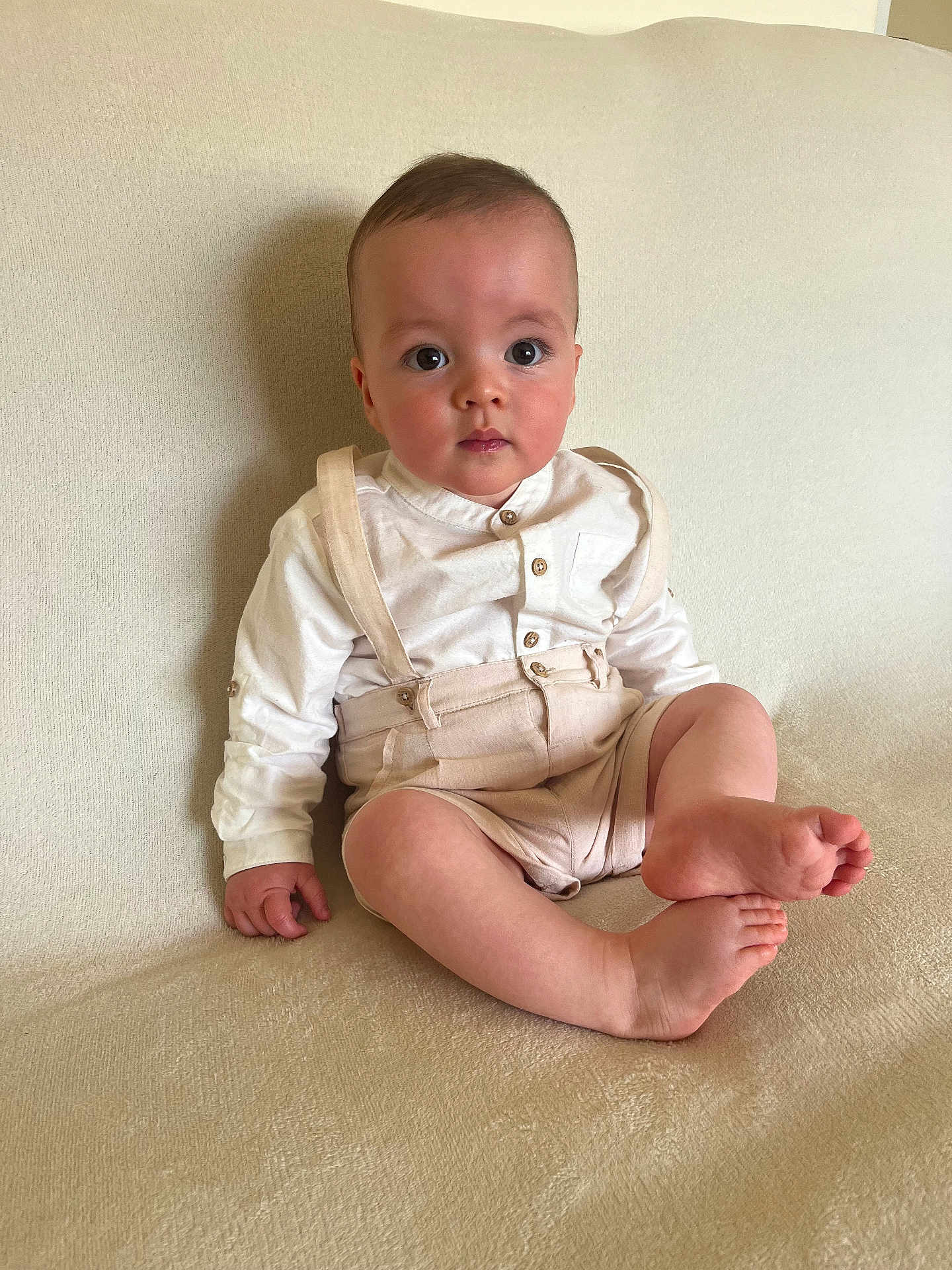 Sunni joined the competition — help win amazing prizes! baby, child, sitting, indoors, couch, clothing, suspenders, white_shirt, barefoot, face, expression, skin, comfort, furniture, portrait, looking, cute, young, person, home