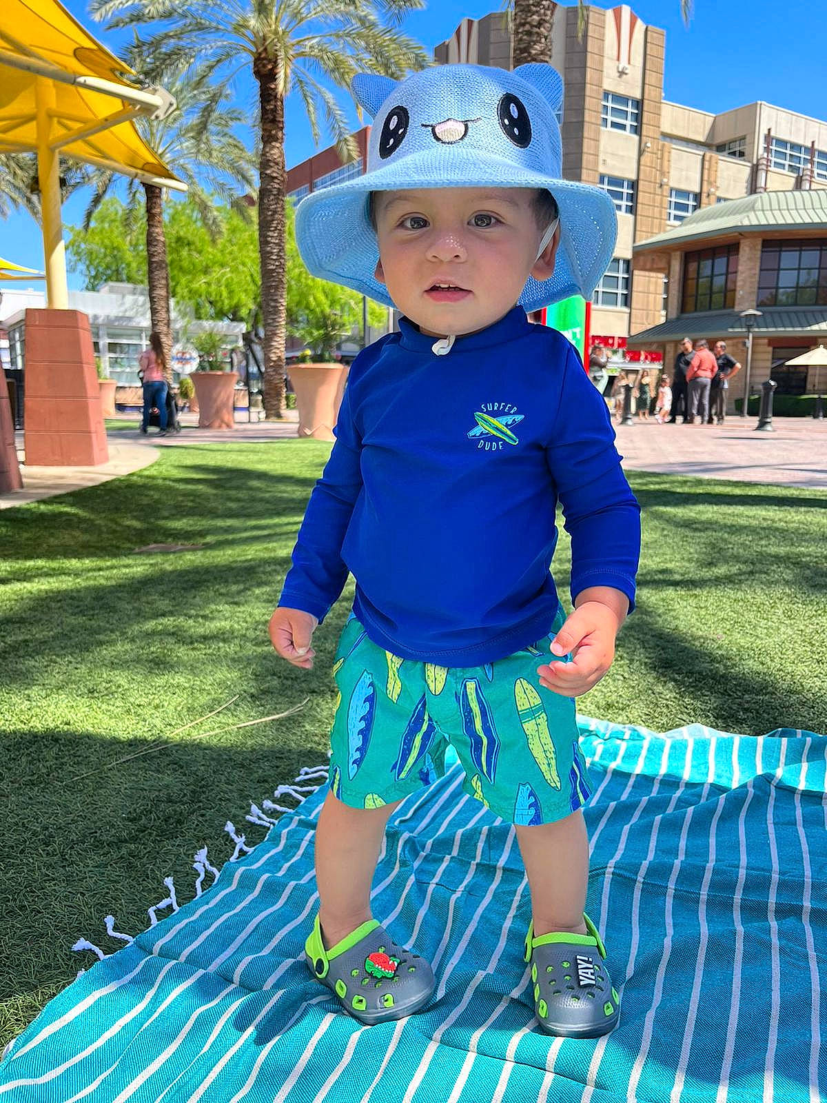 Zyan joined the competition — help win amazing prizes! azure, baby, blue, cap, child, costume_hat, fun, grass, green, headwear, helmet, leaf, leisure, person, photograph, plant, public_space, sky, summer, sun_hat