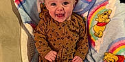 Elsie is registered to the contest to win money with this photo: baby, infant, smiling, blanket, winnie_the_pooh, rainbow, onesie, pajamas, seat, couch, plush, portrait, face, eyes, hands, toes, happy, pattern, fabric, indoor