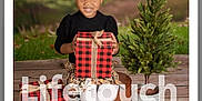 Nevaeh is registered to the contest to win money with this photo: child, christmas, christmasdecorations, christmastree, conifer, face, female, festival, fir, gift, girl, head, person, photography, pine, plant, portrait, pottedplant, tartan, tree