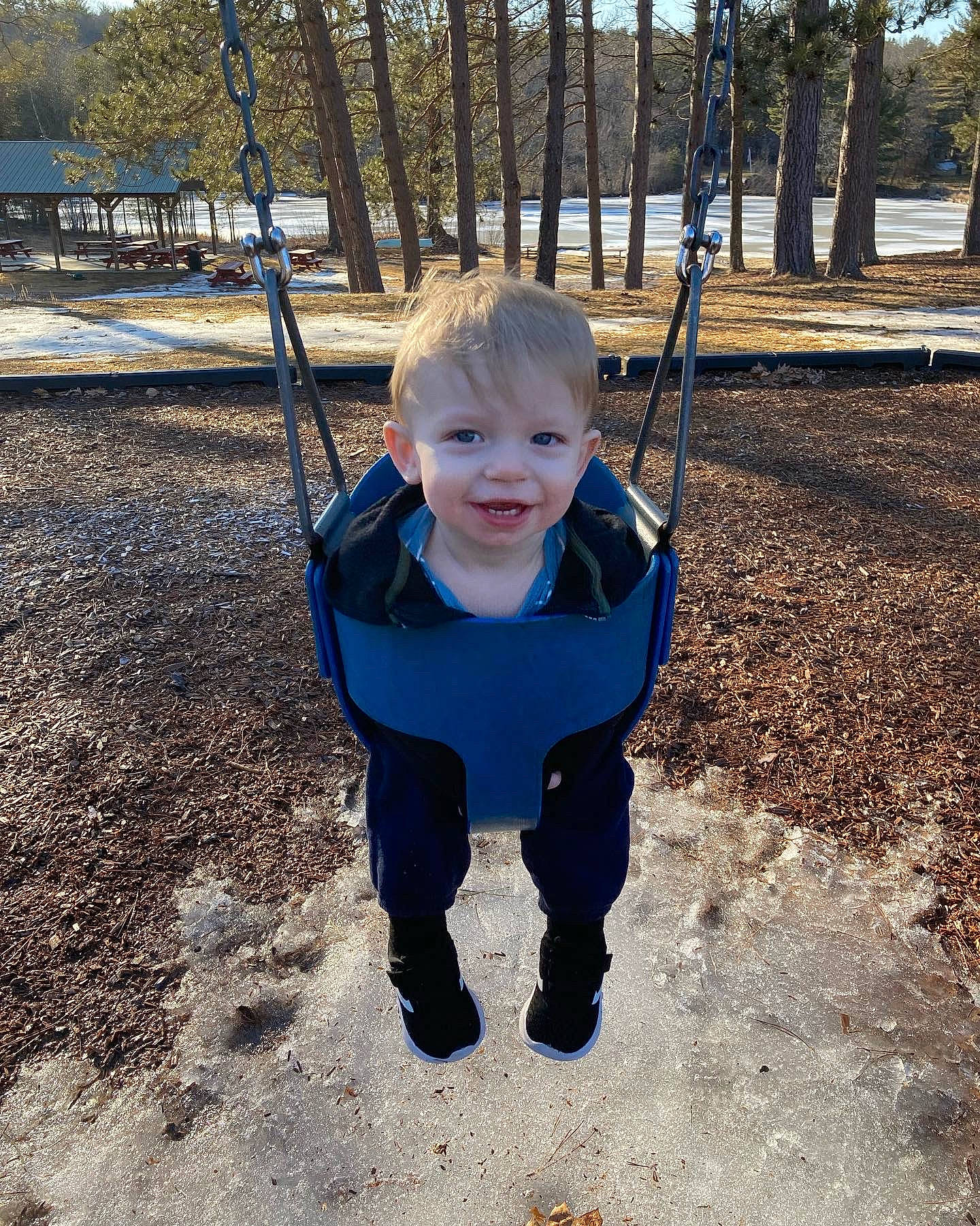 Calvin is registered to the contest to win money with this photo: baby, child, city, electric_blue, eye, fun, grass, happy, joy, leisure, outdoor_play_equipment, people_in_nature, person, playground, recreation, sky, sleeve, smile, standing, swing