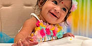 Iyrashambavi is registered to the contest to win money with this photo: baby, child, smiling, high_chair, flower_headband, colorful, celebration, birthday_cake, happy, infant, portrait, decorations, festive, cute, indoors, person, food, table, jewelry, headwear