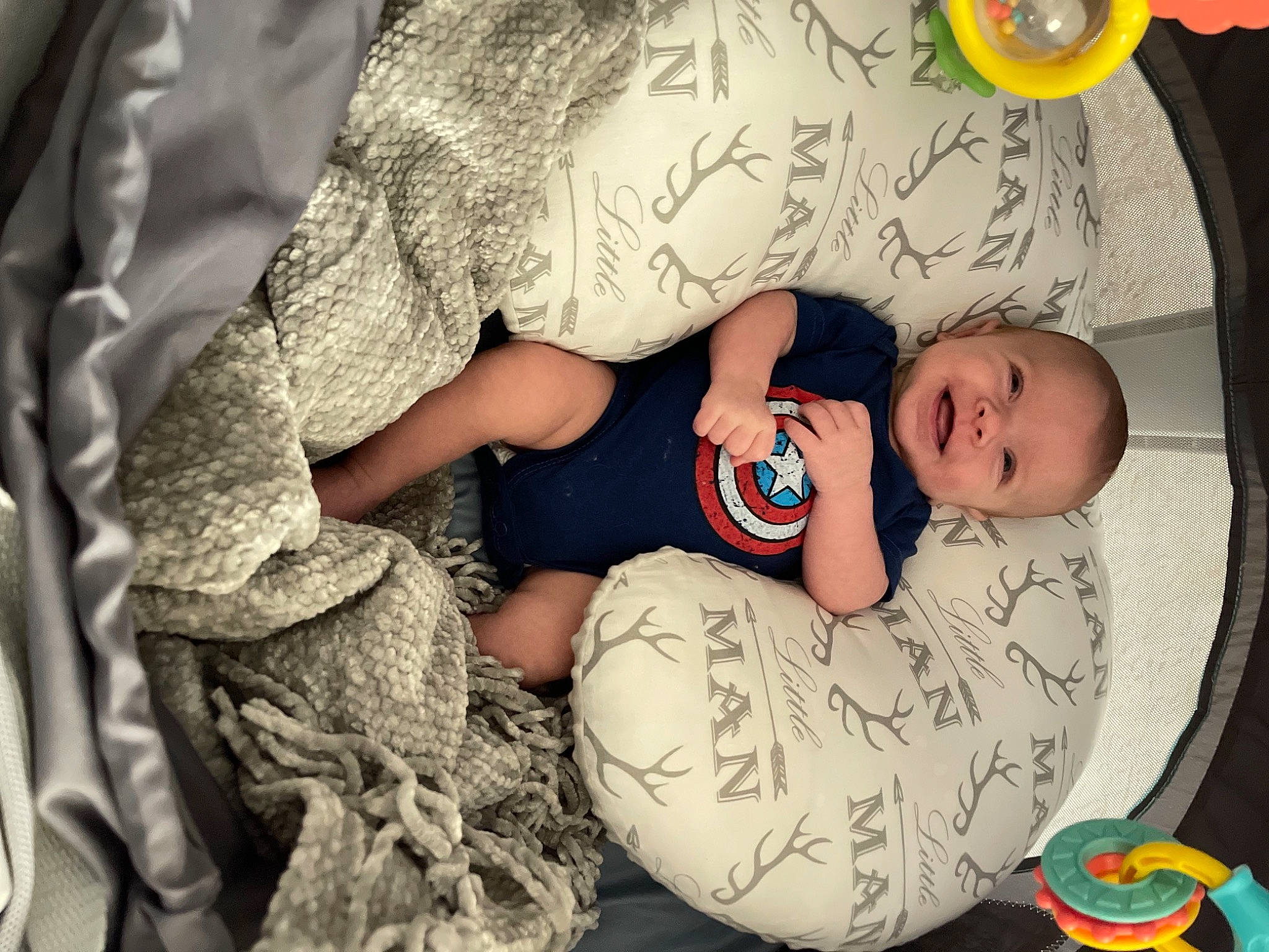 Bowen is registered to the contest to win money with this photo: arm, baby, baby_toddler_clothing, bedtime, child, comfort, eye, facial_expression, finger, fun, gesture, happy, headgear, linens, mouth, pattern, person, skin, textile, toddler