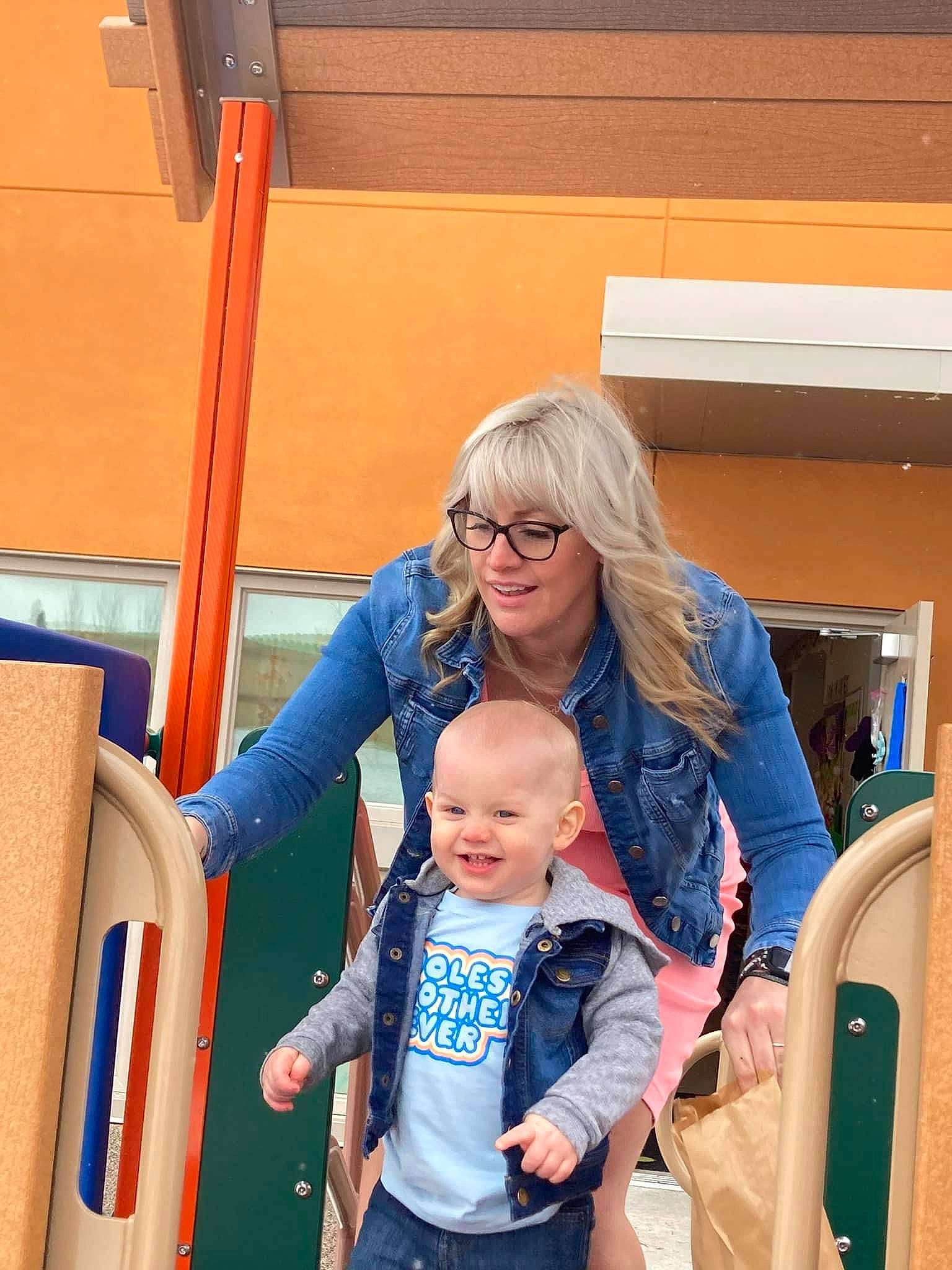 Carter is registered to the contest to win money with this photo: baby, baby_products, baby_toddler_clothing, bag, child, electric_blue, event, eyewear, fun, glasses, happy, joy, leisure, person, recreation, sitting, skin, smile, standing, toddler