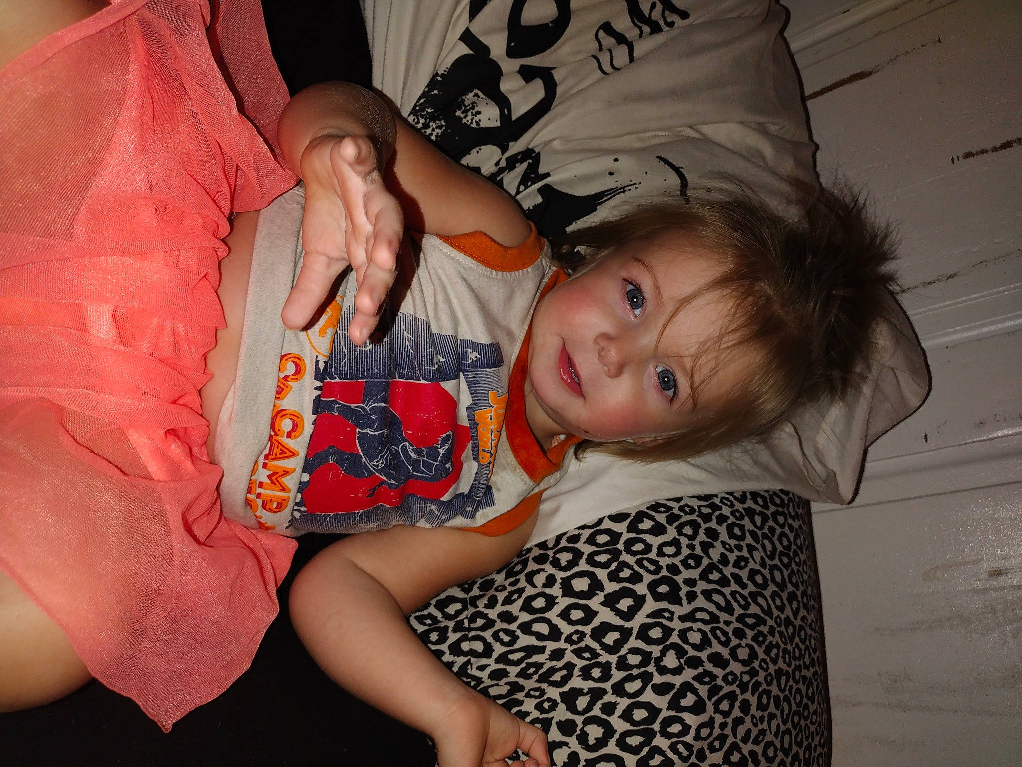 Kennedy is registered to the contest to win money with this photo: baby_toddler_clothing, cheek, child, comfort, flesh, fun, happy, human_leg, lip, mouth, party, pattern, person, pink, room, sitting, smile, t_shirt, thigh, toddler