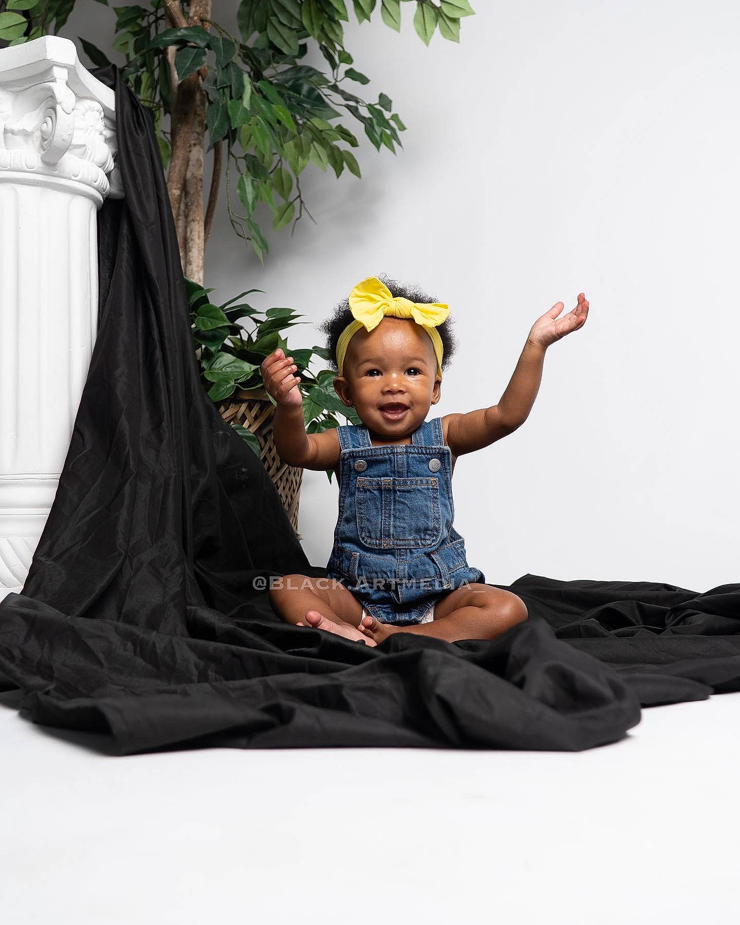 Malaiyah joined the competition — help win amazing prizes! baby, baby_toddler_clothing, child, doll, fun, grass, happy, leisure, people_in_nature, person, plant, shorts, sitting, sleeve, t_shirt, toddler, tree