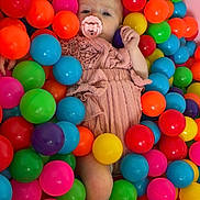 Brighlynn is registered to the contest to win money with this photo: baby, ball_pit, bright_colors, child, childhood, colorful, cute, fun, happy_child, indoor, infant, pacifier, pink_outfit, plastic_balls, play_area, portrait, relaxed, small_child, soft_lighting, toys