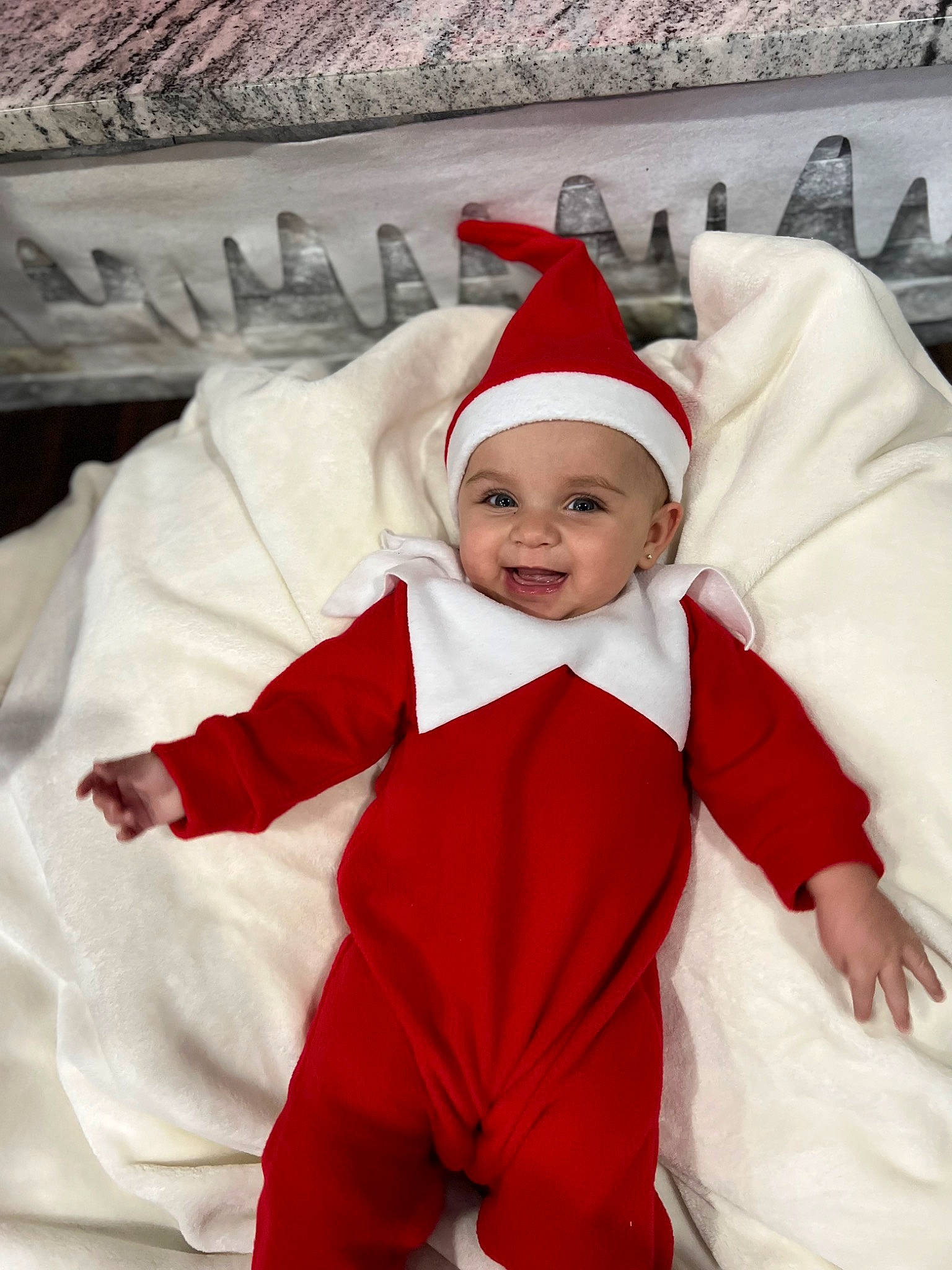 Kaylen is registered to the contest to win money with this photo: baby, baby_toddler_clothing, cap, child, christmas, christmas_eve, comfort, costume_hat, event, face, facial_expression, fictional_character, fur, gesture, happy, headwear, holiday, joy, person, santa_claus