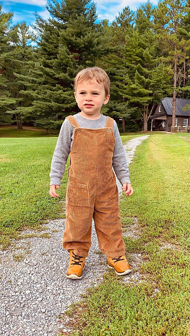 Kasen joined the competition — help win amazing prizes! child, clothing, grass, outerwear, overall, pattern, person, sleeve, standing, toddler