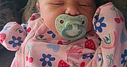 Adelyn joined the competition — help win amazing prizes! baby, infant, sleeping, pacifier, onesie, colorful_clothing, patterned_clothing, flowers, rainbows, strawberries, cherries, couch, cushion, resting, peaceful, indoors, close_up, portrait, child, cute