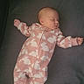 baby, bed, bunny_pattern, child, clothing, cute, face, footed_pajamas, indoor, infant, mattress, newborn, onesie, pacifier, peaceful, pink, resting, sleeping, sleepwear, small
