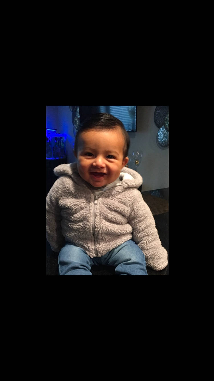 Jadiel joined the competition — help win amazing prizes! arm, baby, cheek, child, chin, cool, face, facial_expression, forehead, head, human, joy, night, nose, outerwear, person, photo_caption, photography, sitting, smile