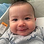 Elijah is registered to the contest to win money with this photo: baby, child, chubby_cheeks, close_up, clothing, cute, dinosaur_pattern, expression, face, hair, happy, indoors, infant, onesie, person, portrait, skin, smile, soft_light, young