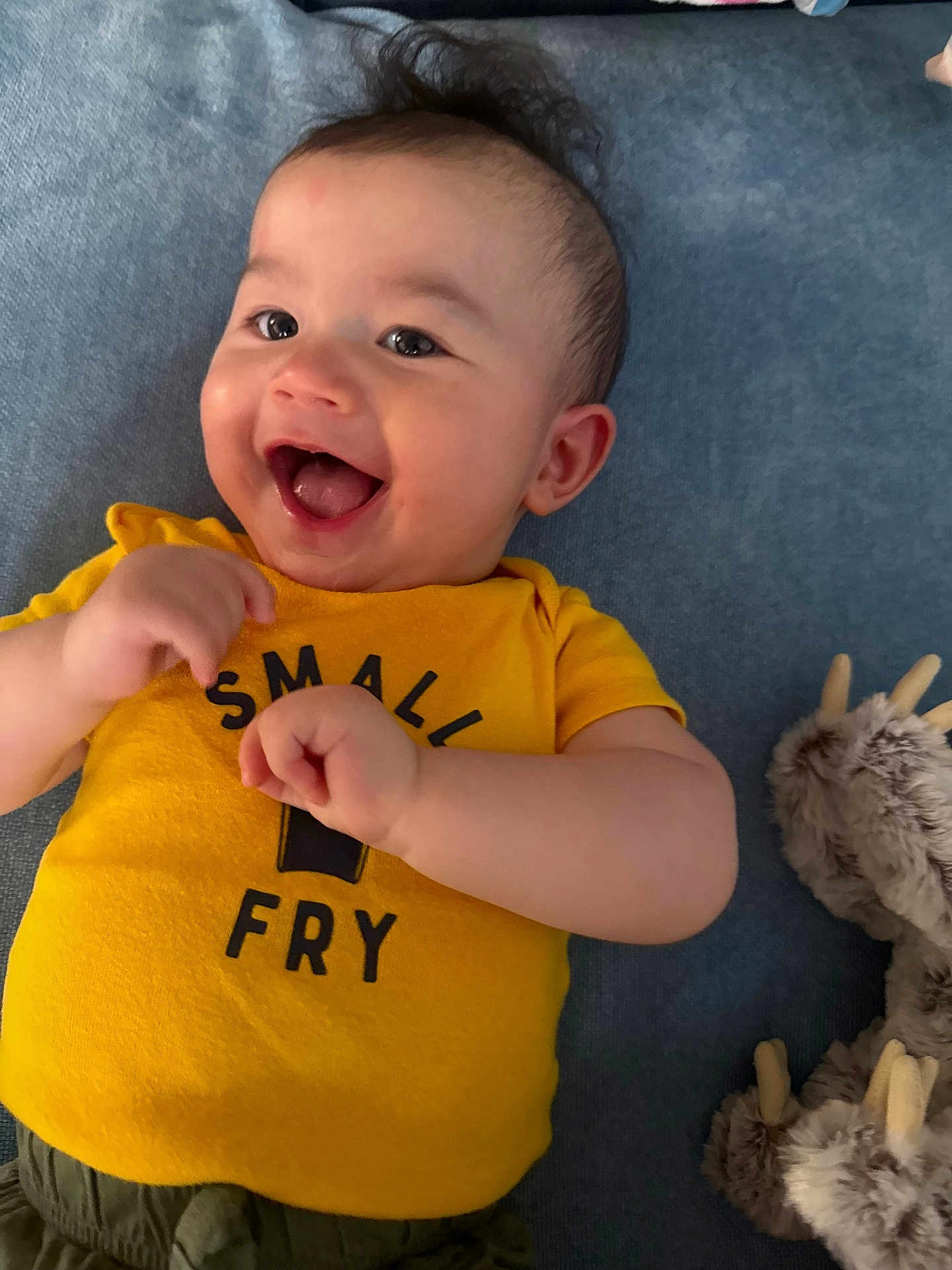 Elijah joined the competition — help win amazing prizes! baby, smiling, yellow_shirt, small_fry, lying_down, blue_background, happy, infant, cute, plush_toy, fuzzy_toy, antlers, child, portrait, indoors, playful, hands, face, mouth_open, joy